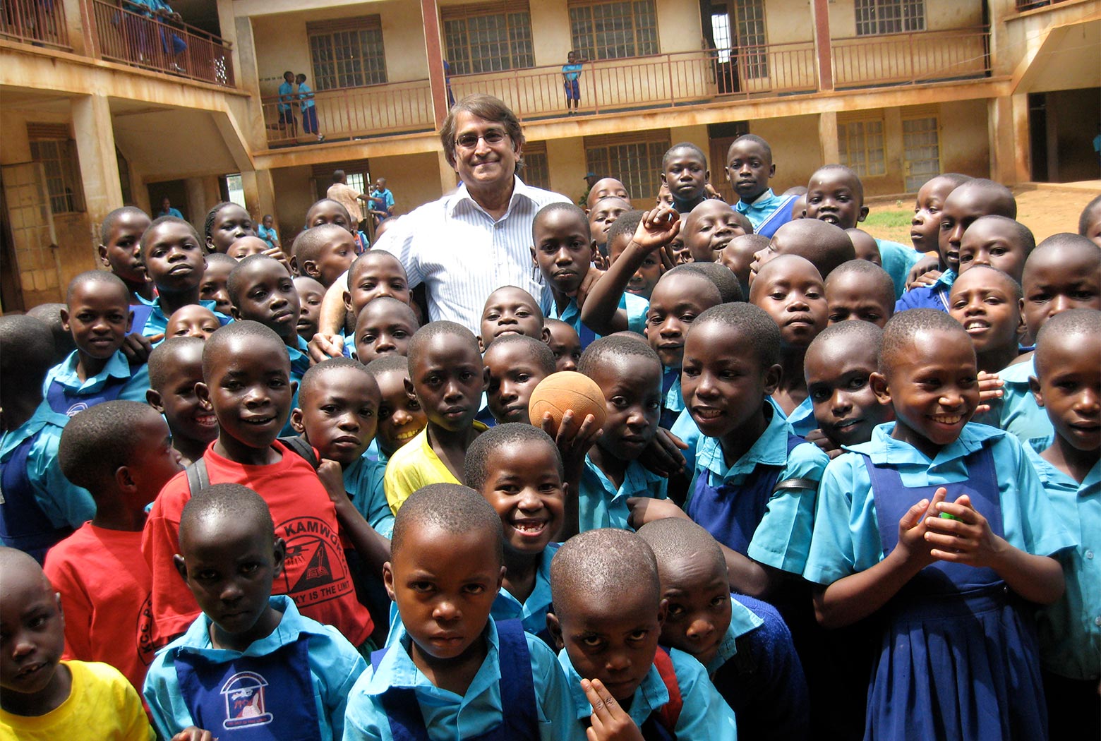 MCF Founder Kish Modha with school children at Kamwoyka Primary School in Kampala, Uganda